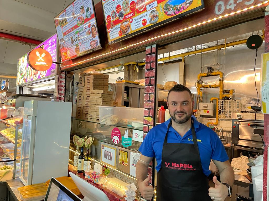 He fled Albania and was an illegal immigrant in Italy. Now he’s a happy hawker in Singapore